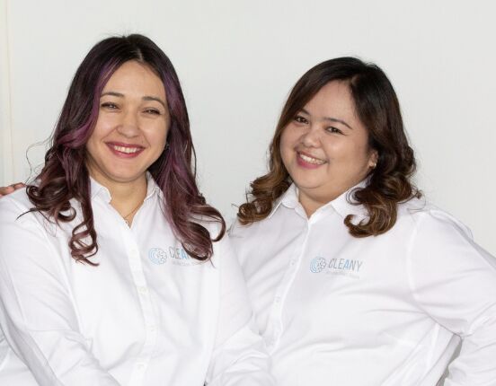 Two Cleany team members in white Cleany shirts